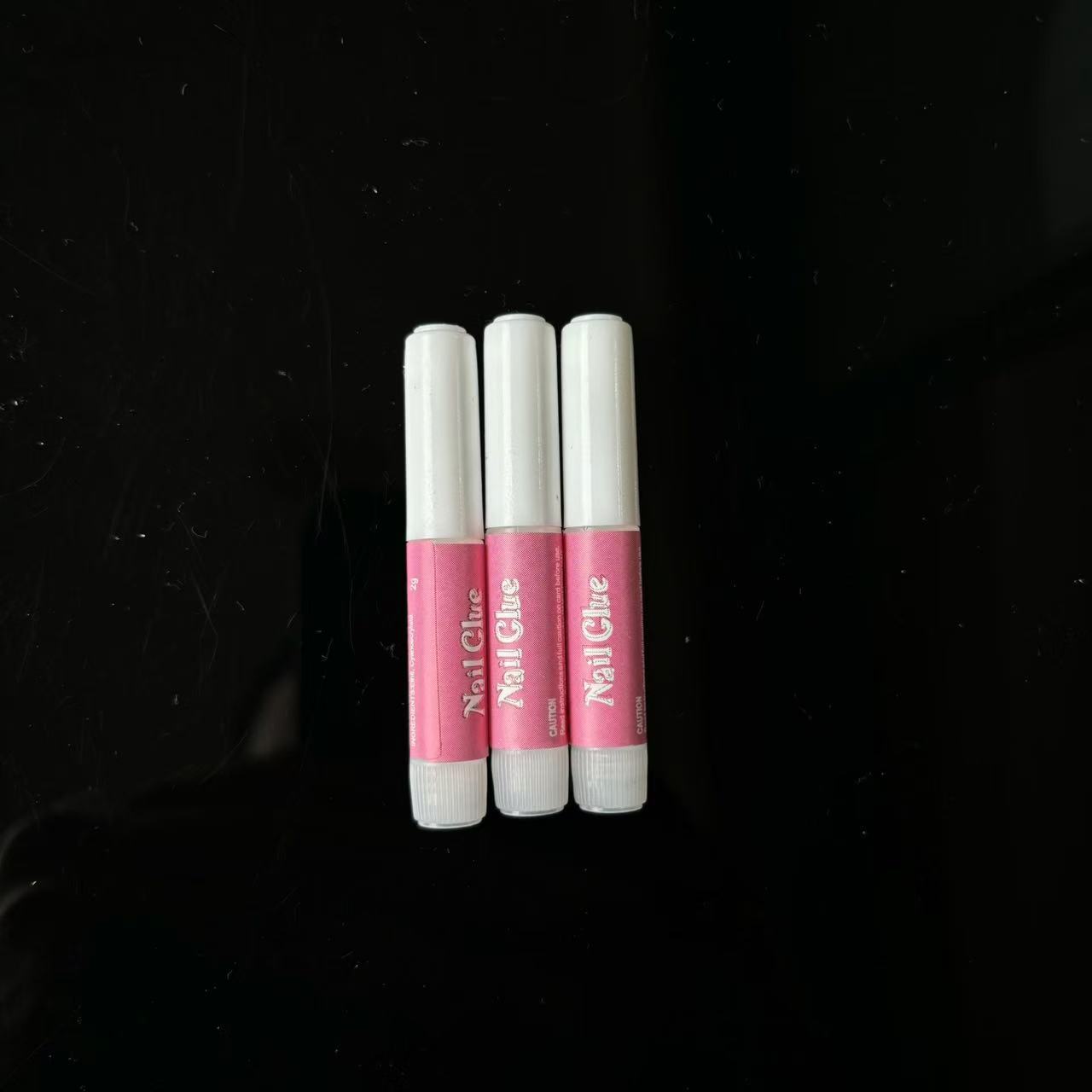 Yiwu manufacturers in stock 2g red tube glue wear nail glue quick-drying nail glue drill glue fake nail glue