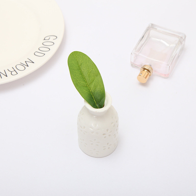 Simulation family green plant ornaments lemon leaf accessories DIY lemon tree leaves Guangdong kapok leaf manufacturers wholesale